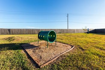 Green mailbox in the middle of a grassy field at Pavilions at Northshore Apartment Homes, Portland, TX